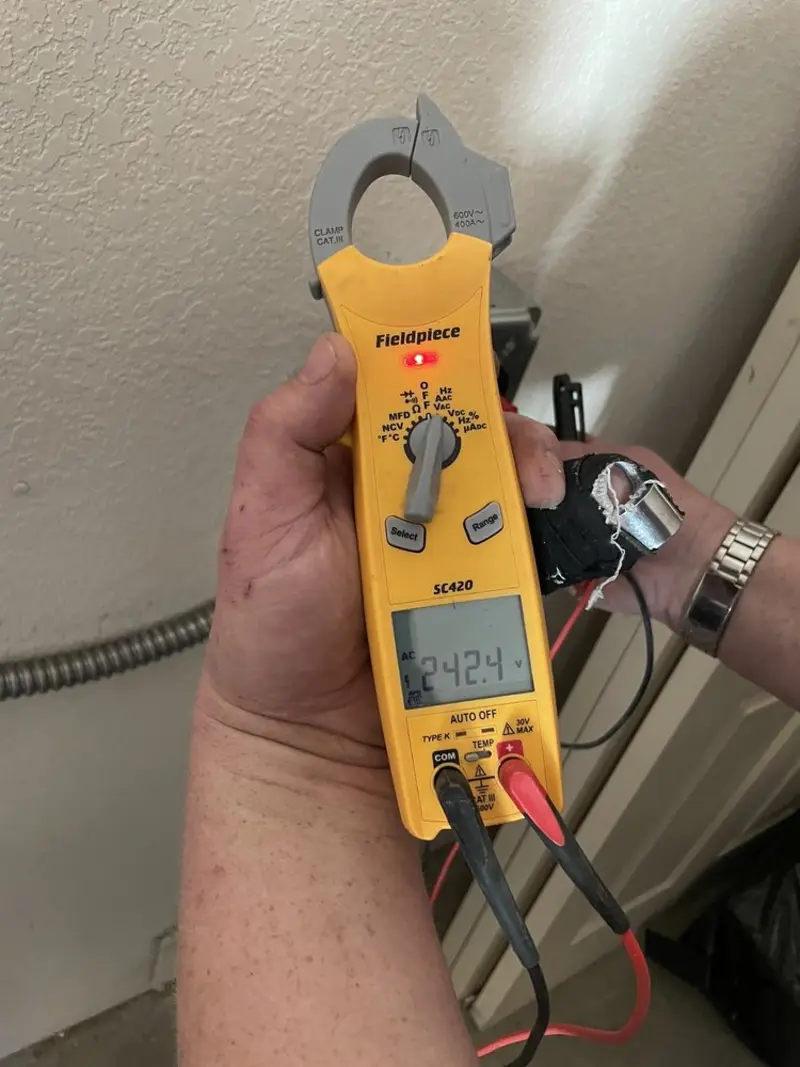 Voltage testing with clamp meter during Electrical Installation Services in Fitzgerald